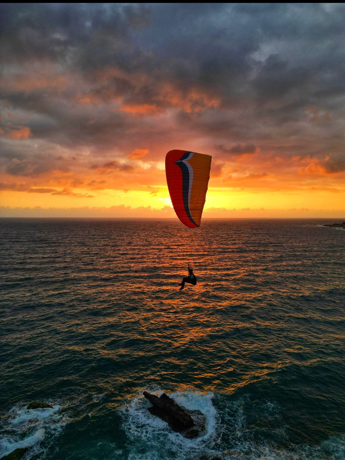 Paraglider at sunset over the Lebanese coast